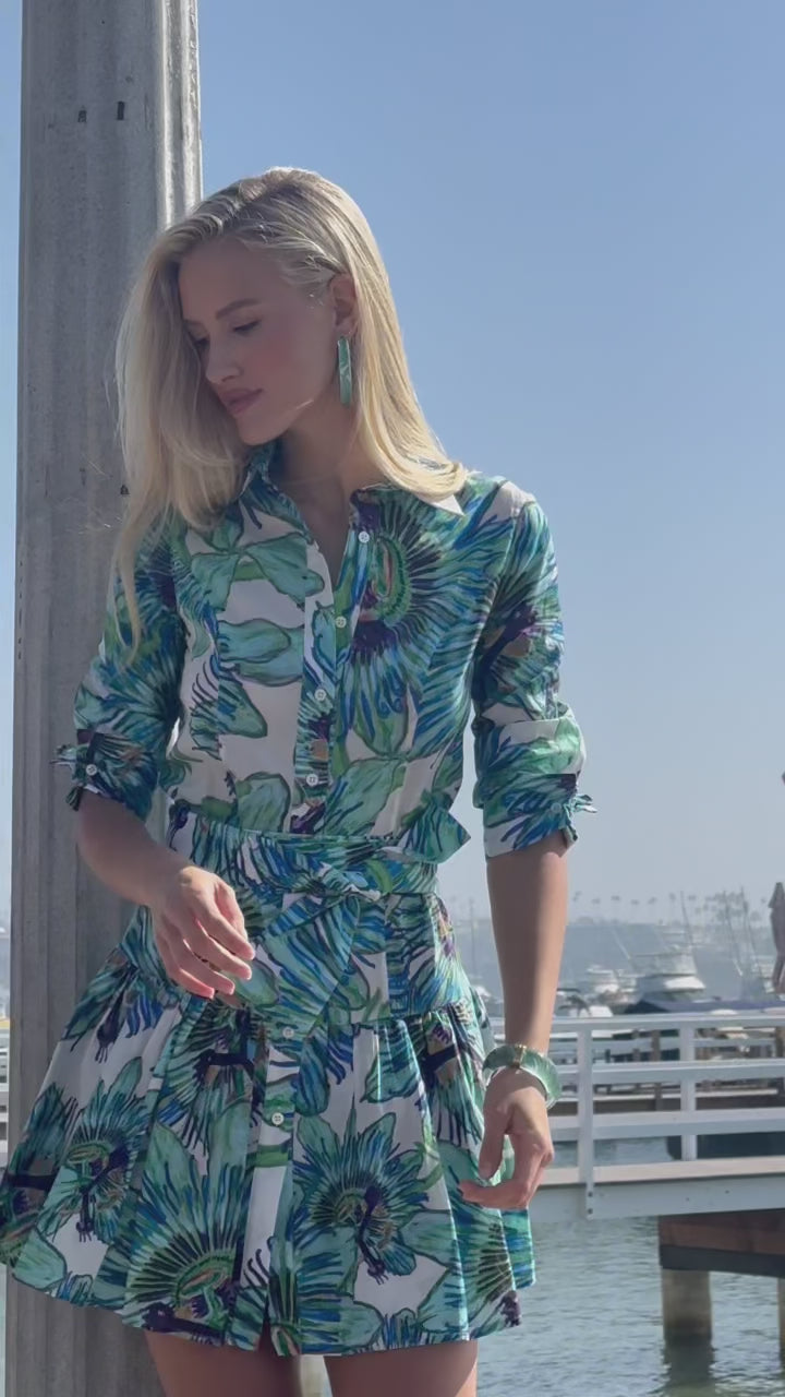 Video of a woman wearing a short floral cotton dress