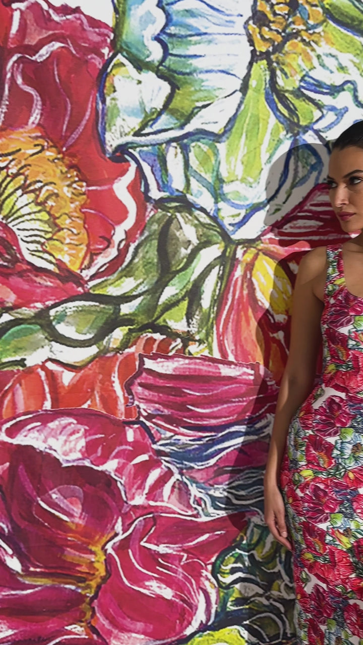 Video of a woman wearing a long stretch knit red floral printed dress by designer Ala von Auersperg for womens luxury travel clothing
