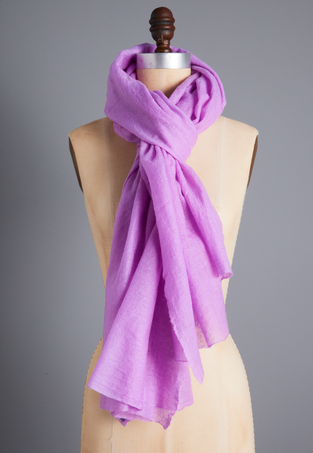 Sheer Lilac purple cashmere wrap draped around a dress form as a long scarf