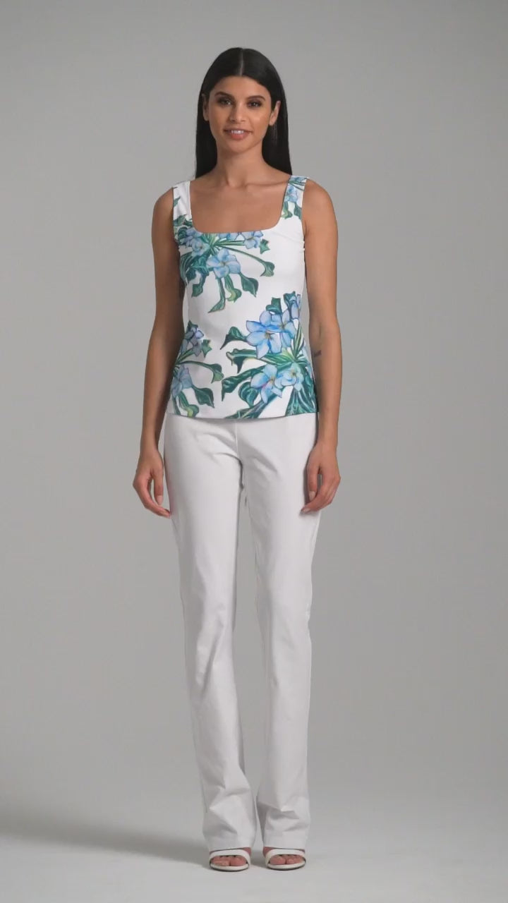 Woman wearing green mock coffee square neck stretch knit tank top with white italian stretch cotton pants by Ala von Auersperg for resort 2023