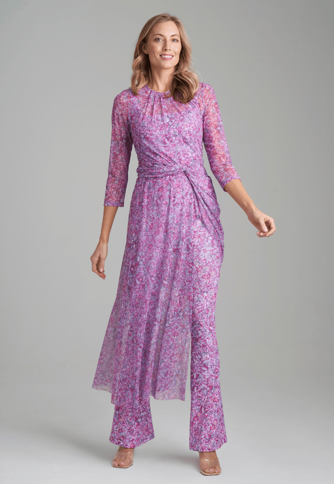 Woman wearing mesh topper in printed pink orchid flowers over stretch knit printed pink orchid flowers over tank top and pants by Ala von Auersperg for resort 2022