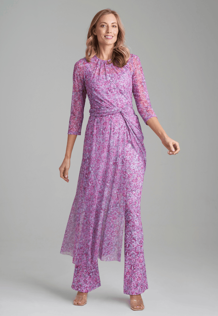 Woman wearing mesh topper in printed pink orchid flowers over stretch knit printed pink orchid flowers over tank top and pants by Ala von Auersperg for resort 2022