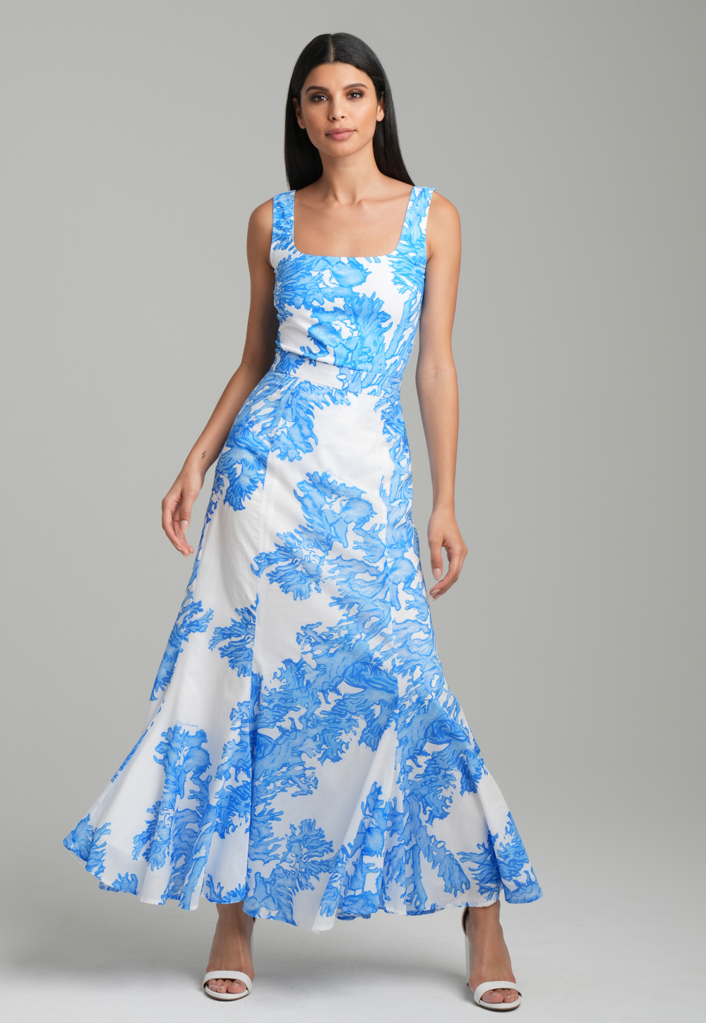 Woman wearing blue coral printed cotton voile long skirt with blue coral printed square neck stretch knit tank top by Ala von Auersperg for resort 2023