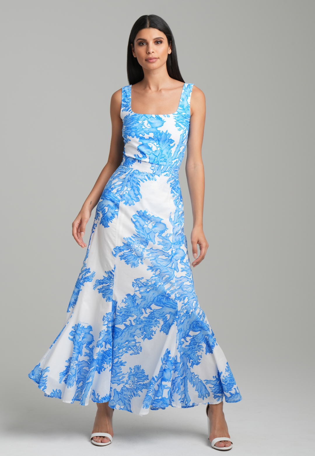 Woman wearing blue coral printed cotton voile long skirt with blue coral printed square neck stretch knit tank top by Ala von Auersperg for resort 2023