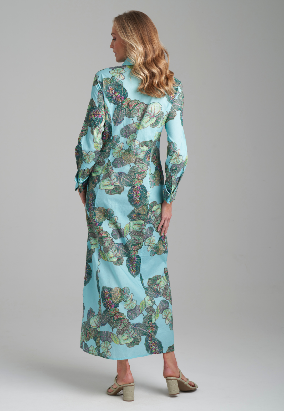 Woman wearing grape leave printed cotton green shirt dress by Ala von Auersperg for resort 2022