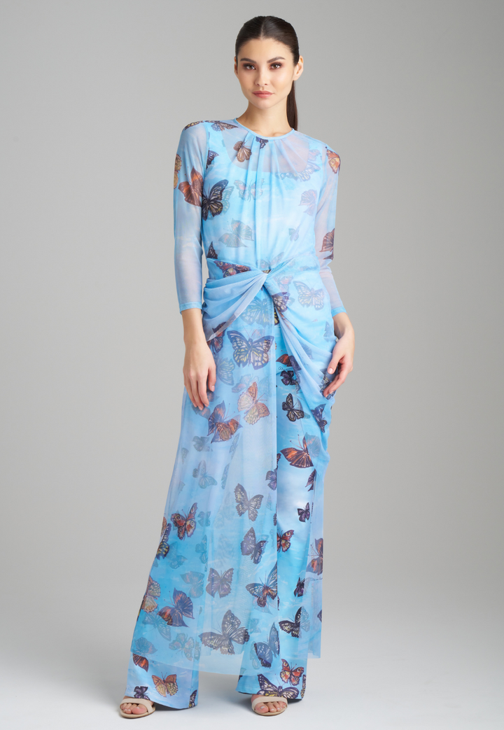 Woman wearing blue butterfly printed mesh topper over blue butterfly printed stretch knit tank top and pants by Ala von Auersperg for spring 2023