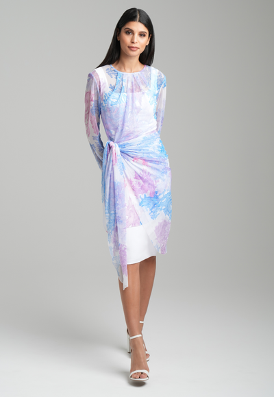 Woman wearing mesh rainbow printed sarong style wrap topper over italian white stretch cotton short dress by Ala von Auersperg for resort 2023