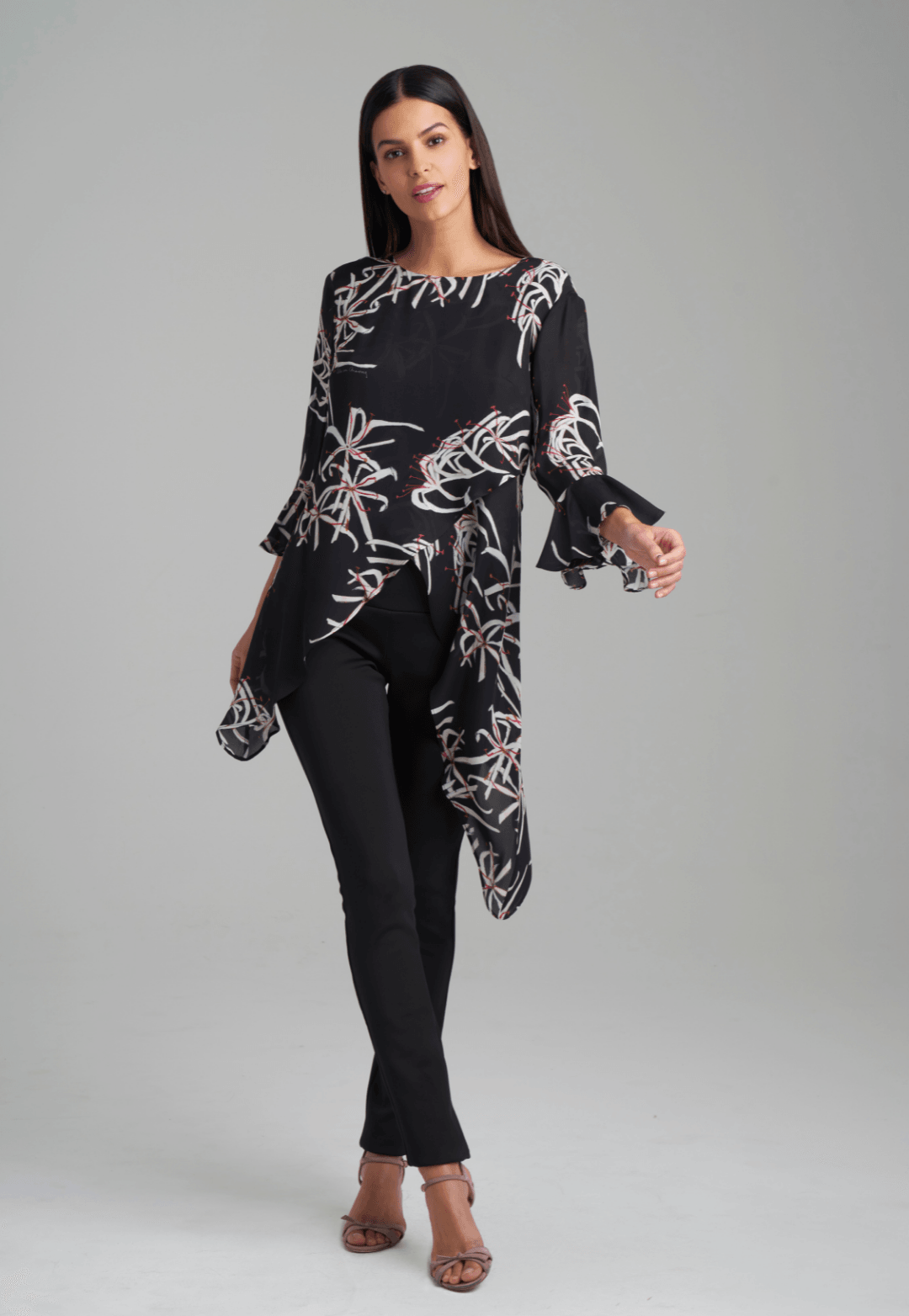 Woman wearing assymetrical black spider lily silk blouse by Ala von Auersperg for holiday 2021