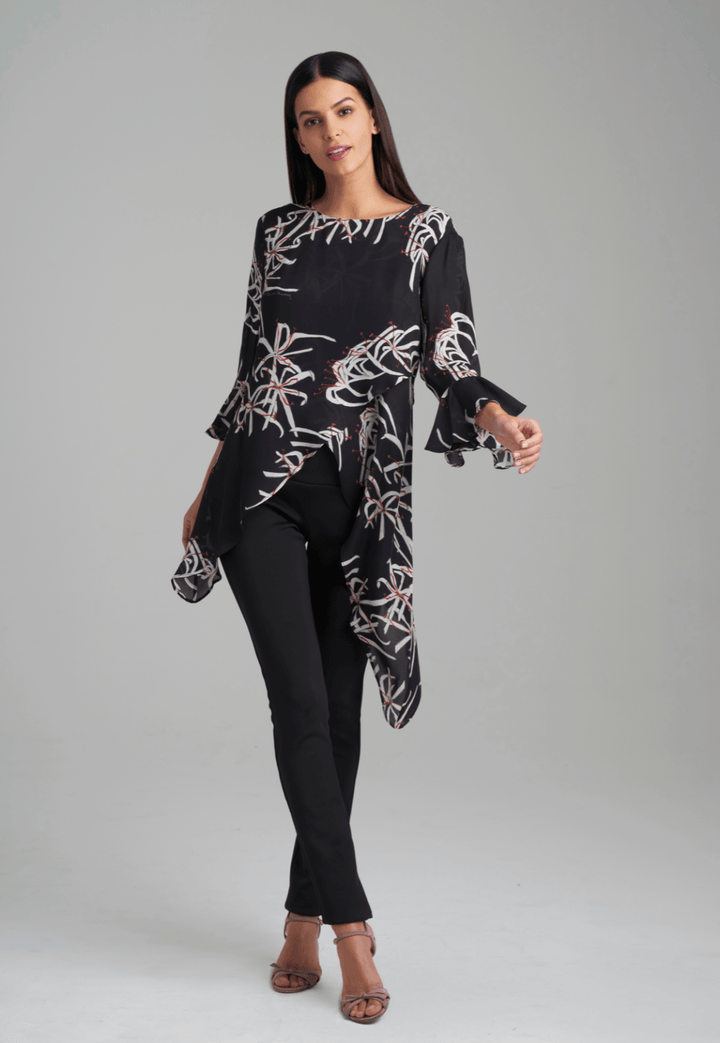 Woman wearing assymetrical black spider lily silk blouse by Ala von Auersperg for holiday 2021