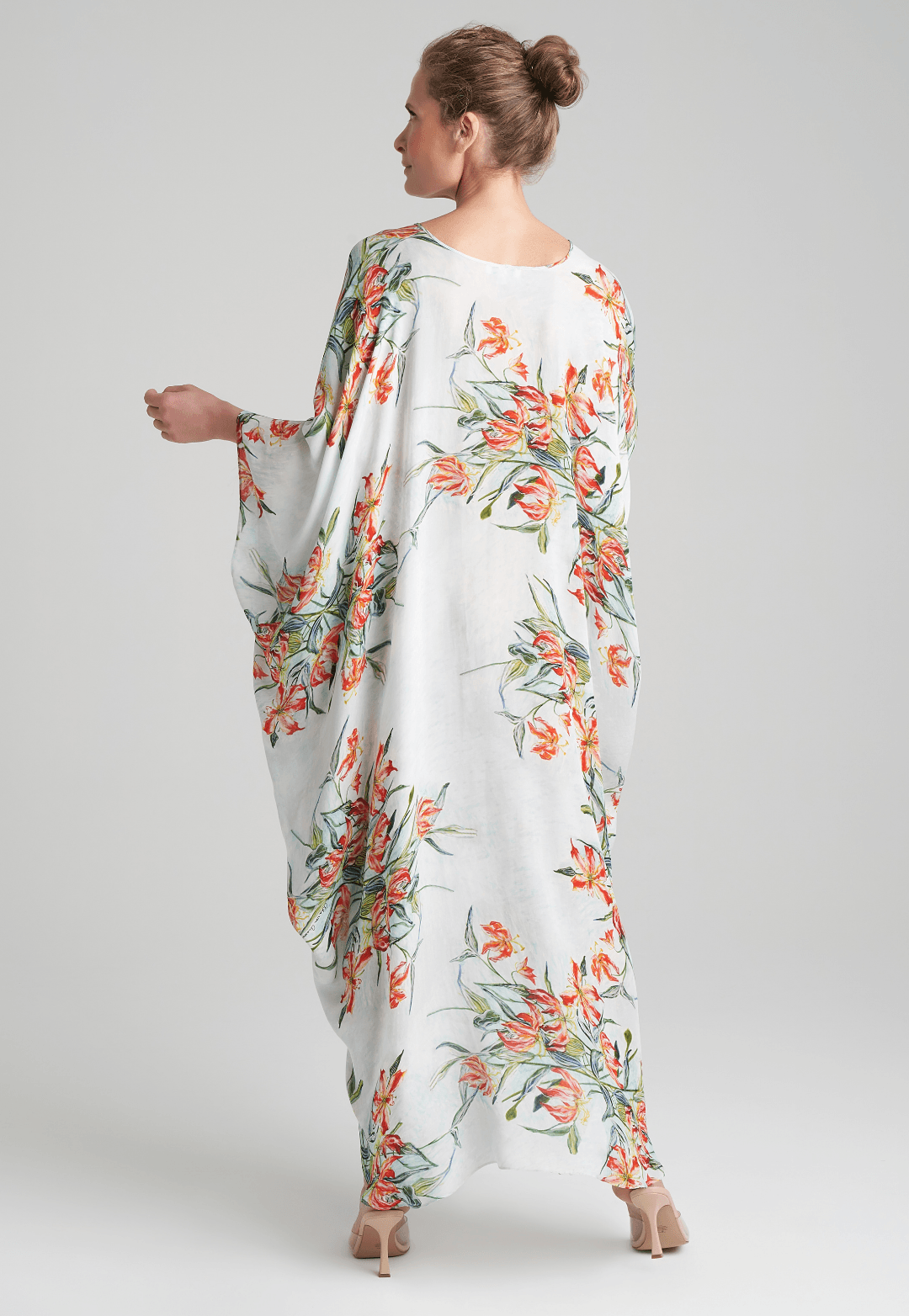 woman wearing blue spider lily printed v neck silk kaftan by Ala von Auersperg