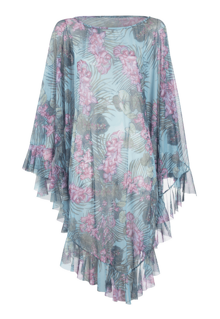 Woman wearing mesh printed orchid and palm poncho over stretch knit tank top and stretch knit pant printed in orchid and palm