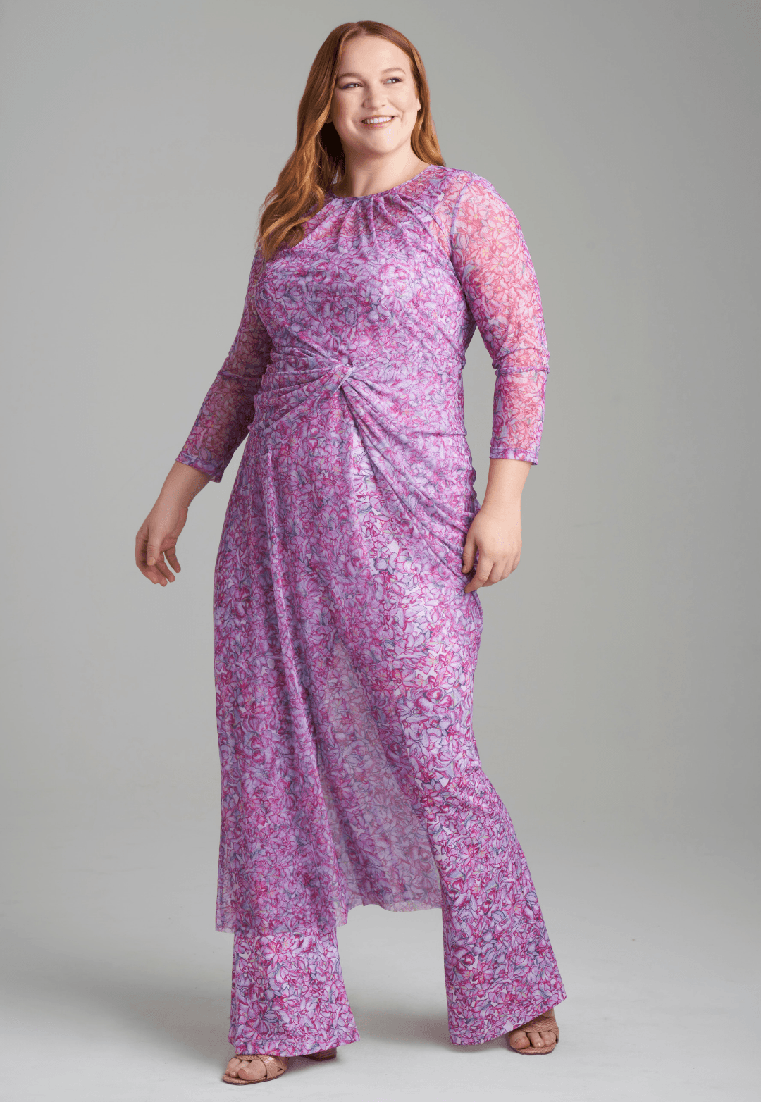 Woman wearing mesh topper in printed pink orchid flowers over stretch knit printed pink orchid flowers over tank top and pants by Ala von Auersperg for resort 2022