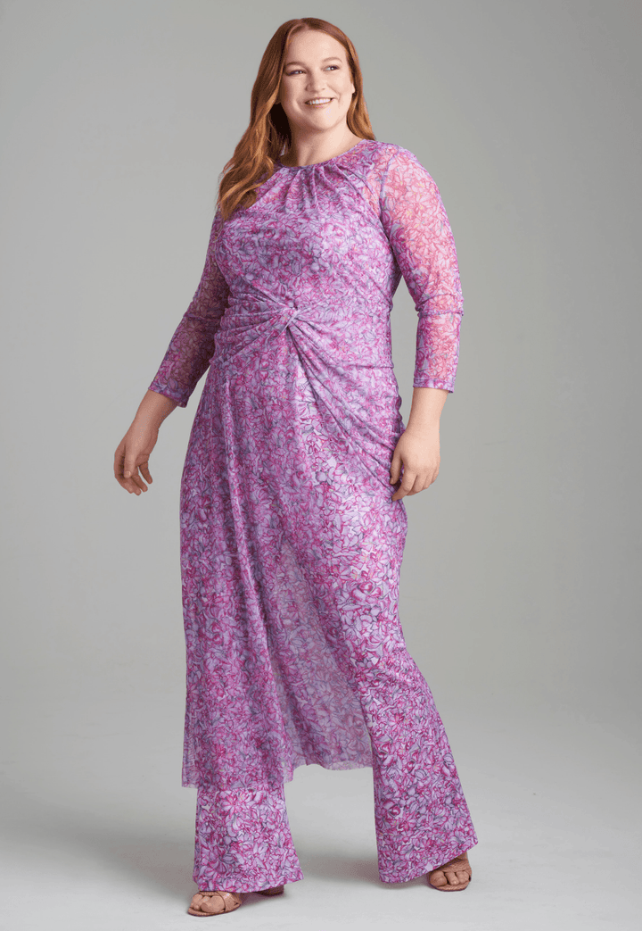 Woman wearing mesh topper in printed pink orchid flowers over stretch knit printed pink orchid flowers over tank top and pants by Ala von Auersperg for resort 2022