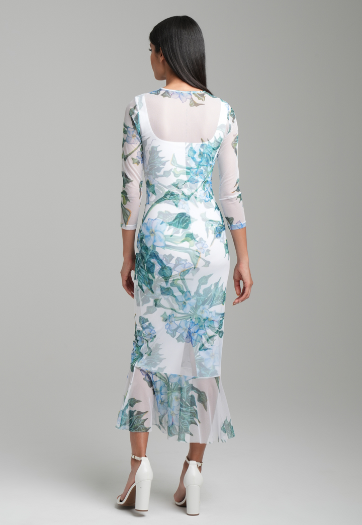 Woman wearing green mock coffee printed mesh dress with ruffle bottom over stretch knit mock coffee square necks short dress by Ala von Auersperg for resort 2023