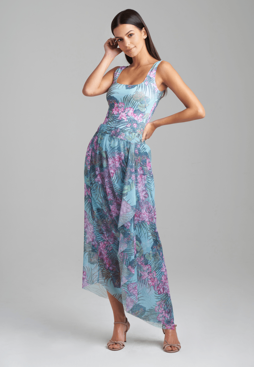 Woman wearing stretch knit tank top in green orchid and palm print with mesh printed orchid and palm green skirt by Ala von Auersperg for resort 2022