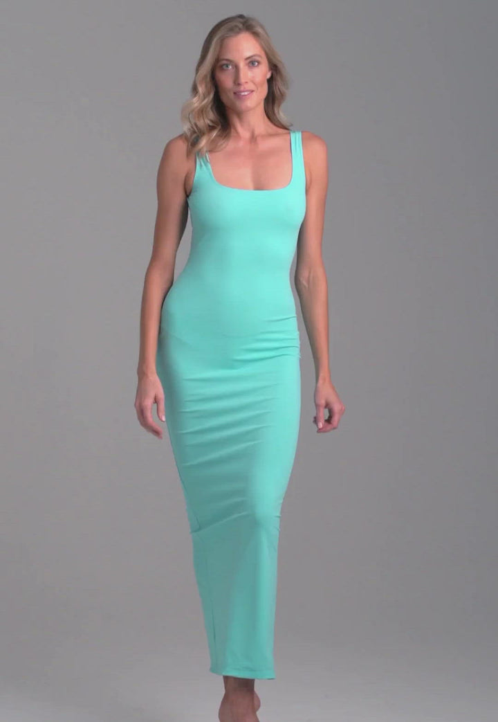 Woman wearing long square neck stretch knit blue green dress by Ala von Auersperg for resort 2022