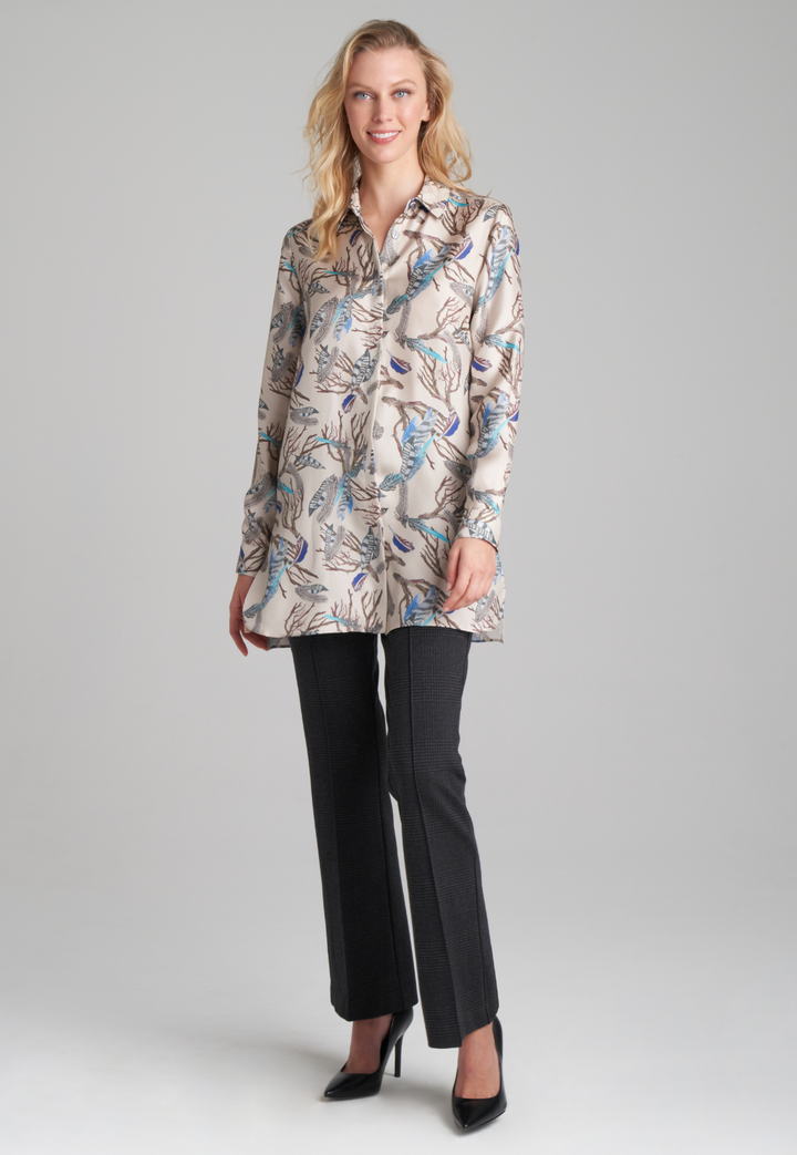 Woman wearing printed silk feather blouse with stretch knit plaid pants by Ala von Auersperg for fall 2022