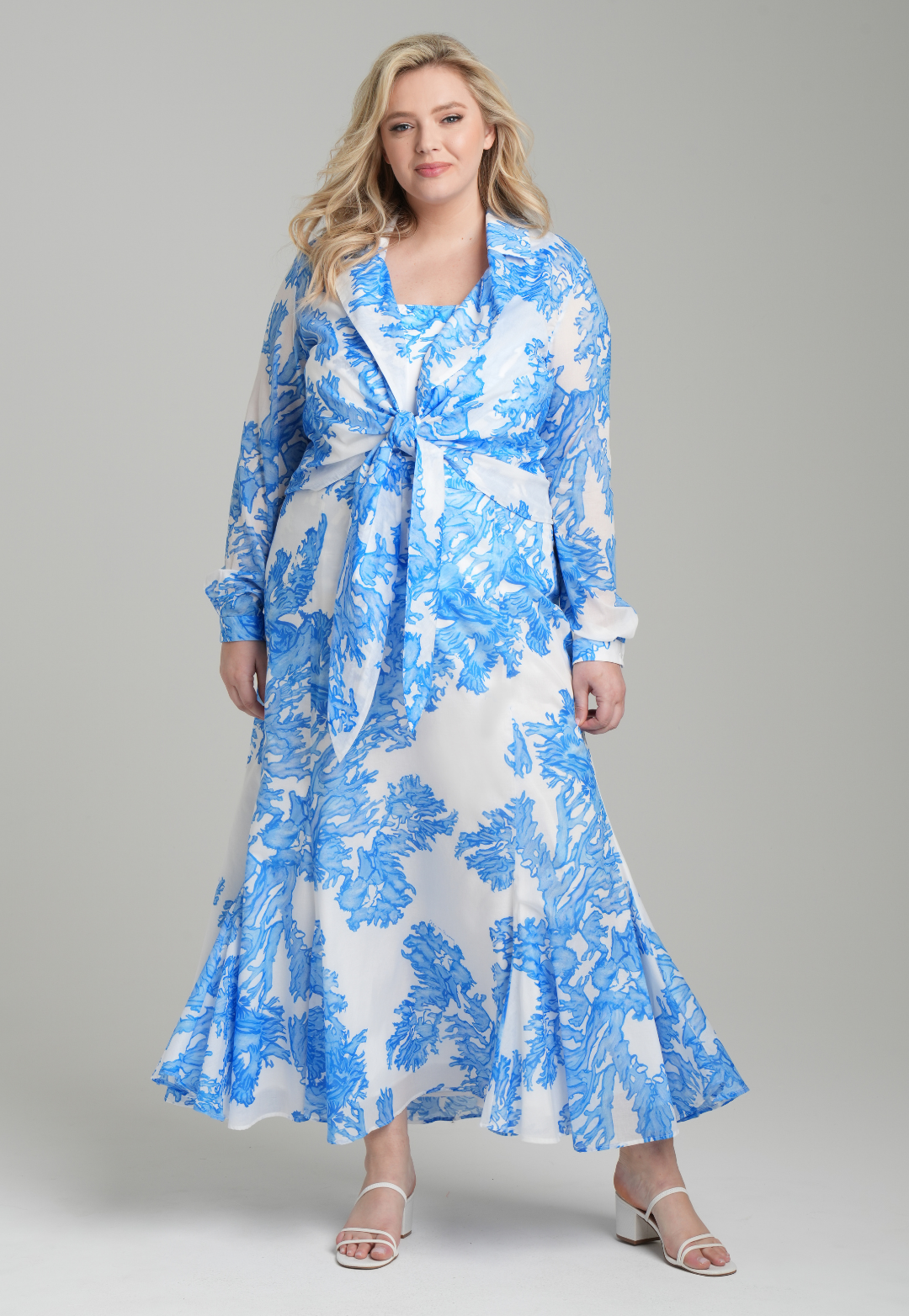 Woman wearing blue coral printed cotton voile long skirt with blue coral printed square neck stretch knit tank top and blue coral printed cotton wrap top by Ala von Auersperg for resort 2023