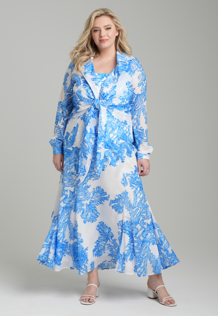 Woman wearing blue coral printed cotton voile long skirt with blue coral printed square neck stretch knit tank top and blue coral printed cotton wrap top by Ala von Auersperg for resort 2023