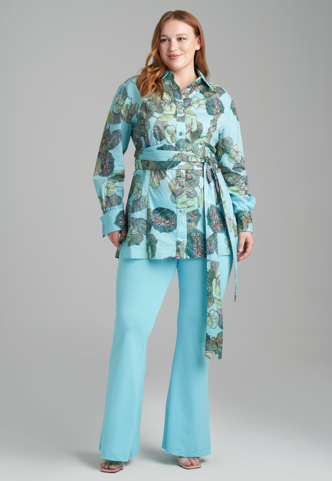 Woman wearing grape leaf cotton blouse with stretch knit blue pants by Ala von Auersperg for resort 2022