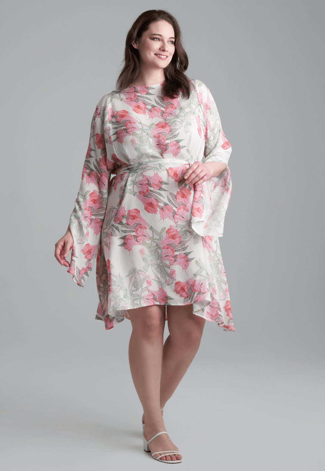 Woman wearing short flower printed silk cocktail dress with long sleeves by Ala von Auersperg for spring summer 2022