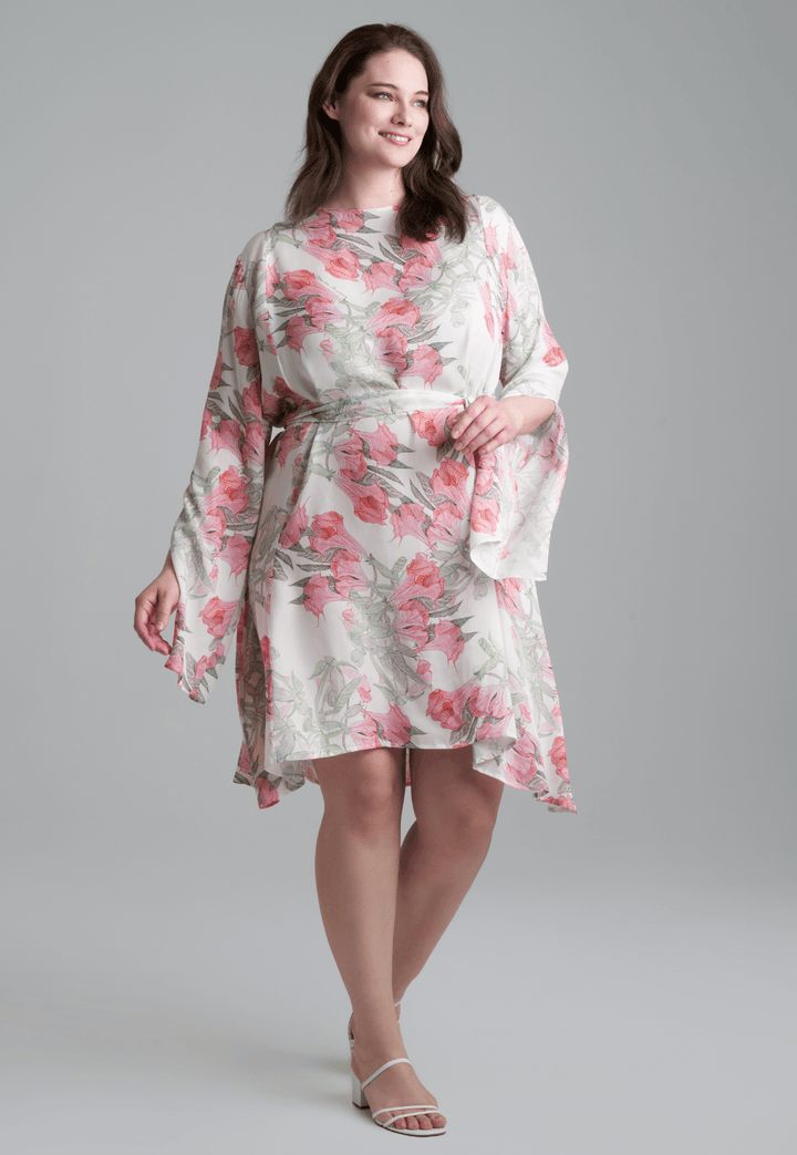 Woman wearing short flower printed silk cocktail dress with long sleeves by Ala von Auersperg for spring summer 2022