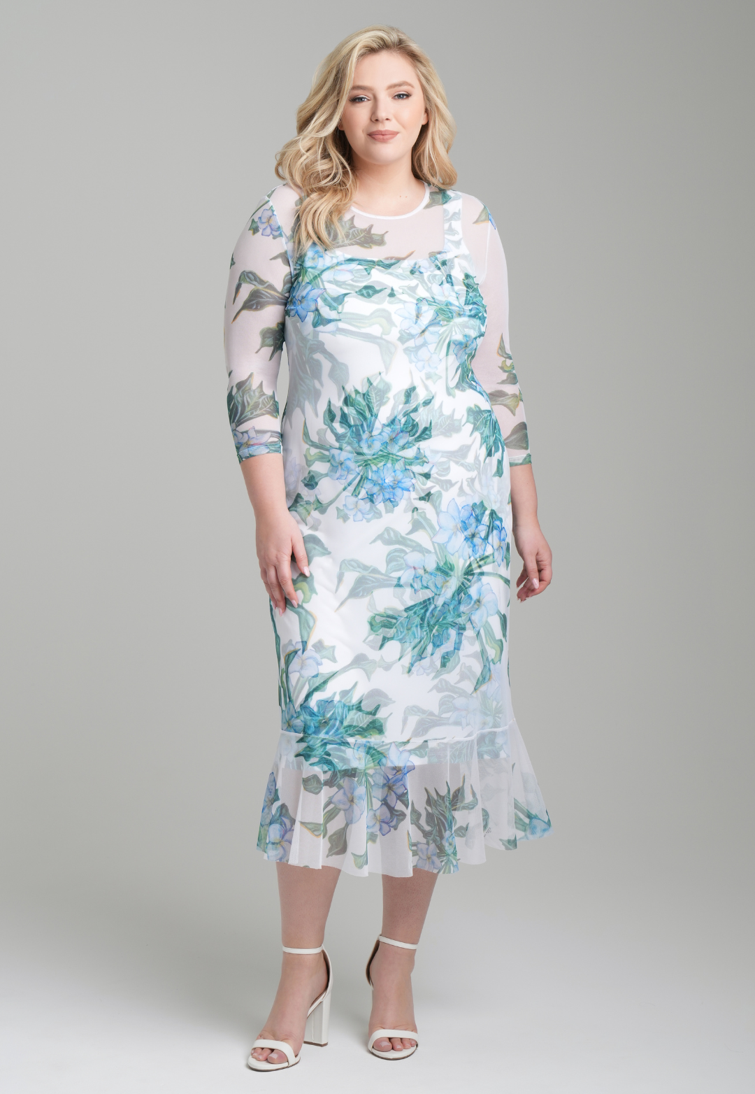 Woman wearing green mock coffee printed stretch knit short square neck dress with mesh dress over it by Ala von Auersperg for resort 2023