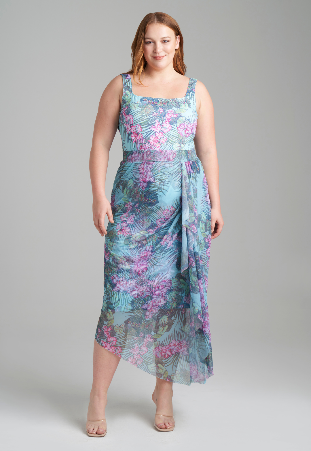 Woman wearing stretch knit tank top in green orchid and palm print with mesh printed orchid and palm green skirt by Ala von Auersperg for resort 2022