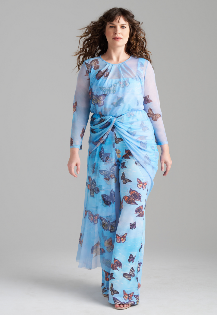 Woman wearing blue butterfly printed mesh topper over blue butterfly printed stretch knit tank top and pants by Ala von Auersperg for spring 2023