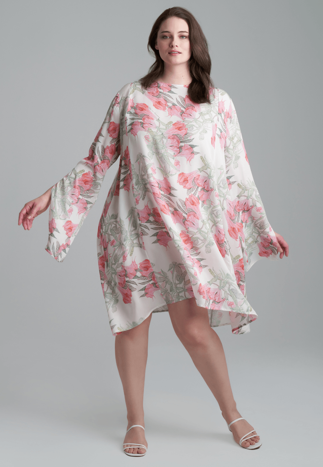 Woman wearing short flower printed silk cocktail dress with long sleeves by Ala von Auersperg for spring summer 2022