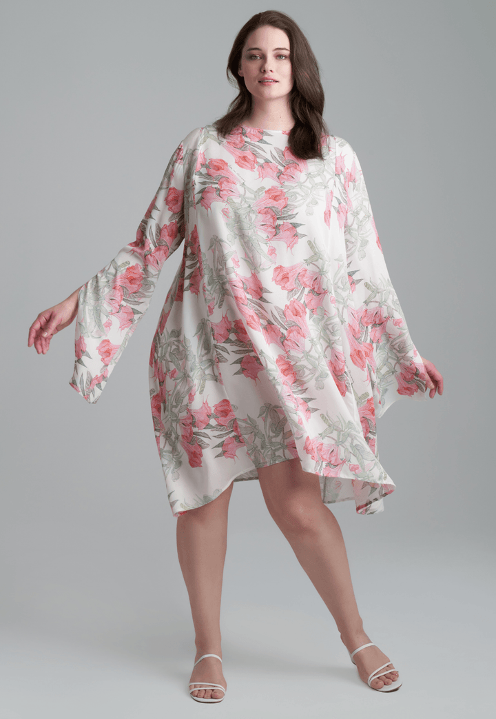 Woman wearing short flower printed silk cocktail dress with long sleeves by Ala von Auersperg for spring summer 2022