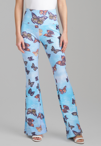 Woman wearing blue butterfly printed stretch knit pants by Ala von Auersperg for spring 2023
