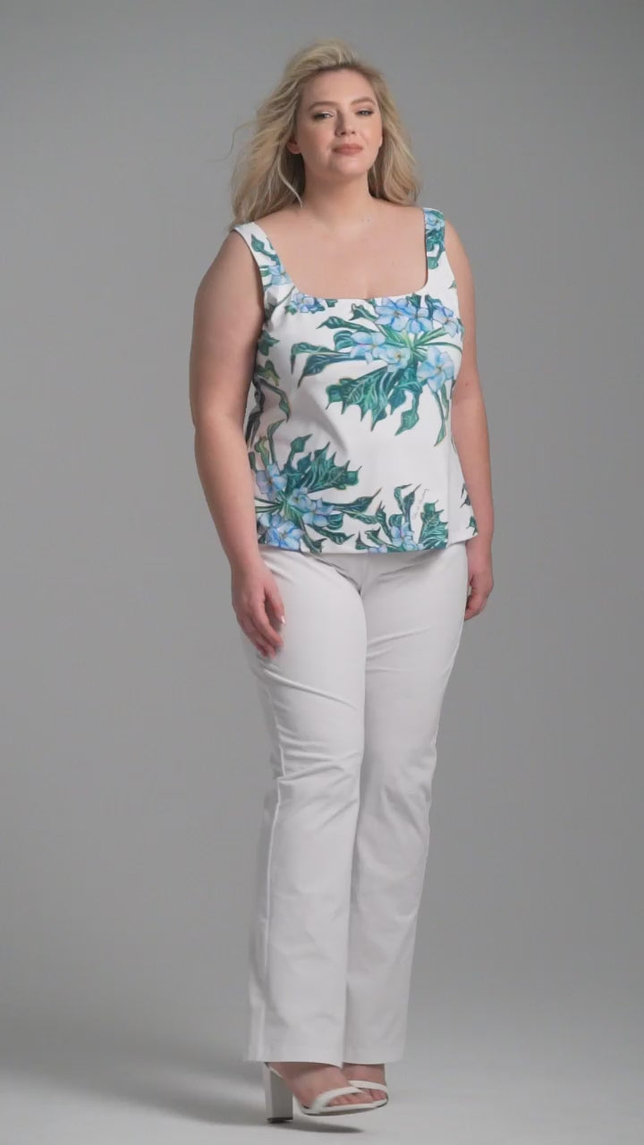 Woman wearing green mock coffee square neck stretch knit tank top with white italian stretch cotton pants by Ala von Auersperg for resort 2023