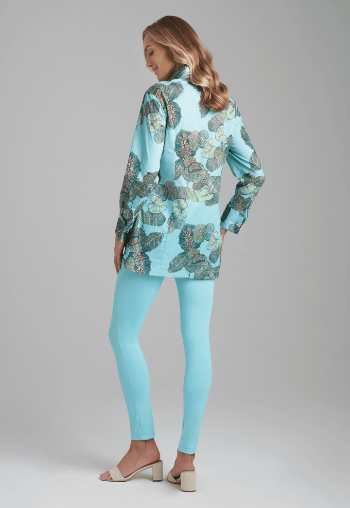 Woman wearing grape leaf cotton blouse with stretch knit blue pants by Ala von Auersperg for resort 2022