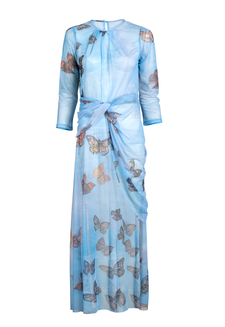 Woman wearing blue butterfly printed mesh topper over blue butterfly printed stretch knit tank top and pants by Ala von Auersperg for spring 2023