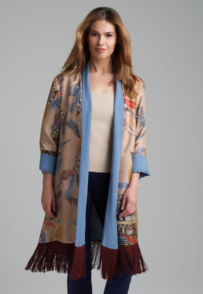 Woman wearing silk feather printed reversible robe and stretch knit tank top and pants by Ala von Auersperg