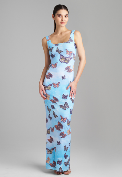 Woman wearing blue butterfly printed long stretch knit dress by Ala von Auersperg for spring 2023
