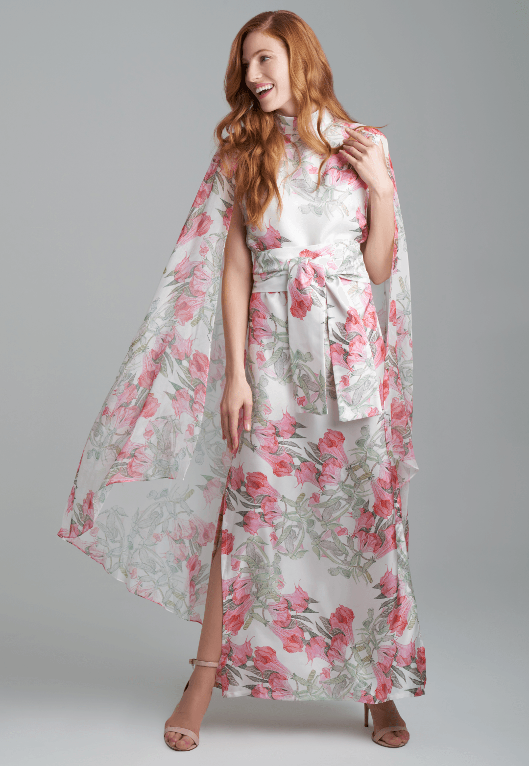 Woman wearing flower printed long turtleneck silk dress with silk attached cape by Ala von Auersperg for spring summer 2022