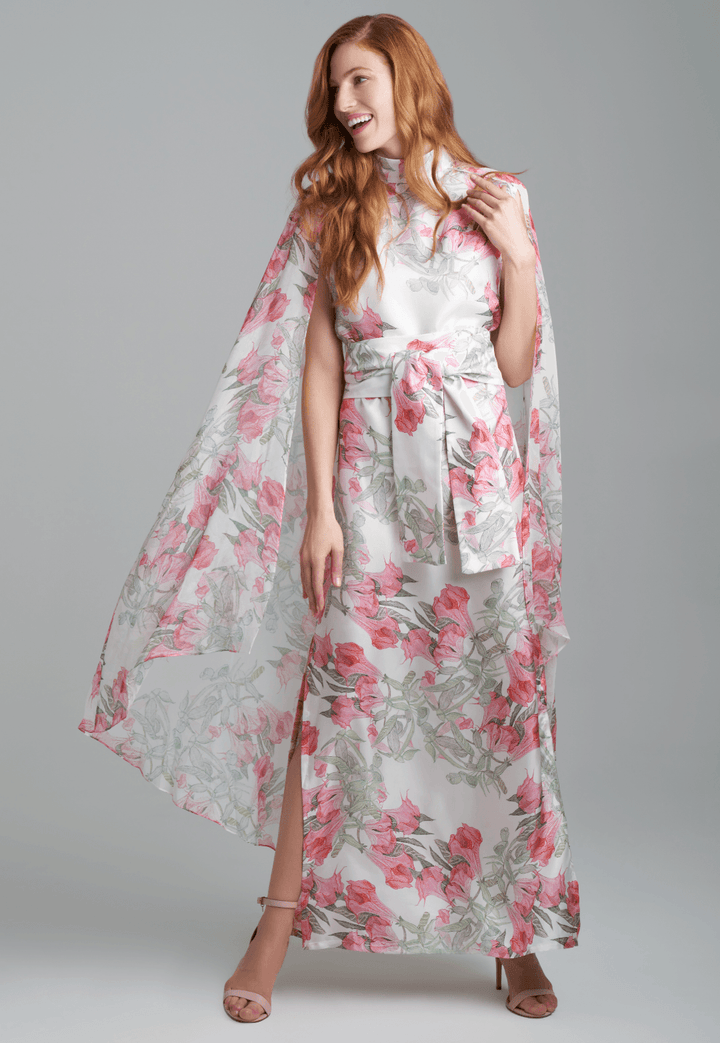 Woman wearing flower printed long turtleneck silk dress with silk attached cape by Ala von Auersperg for spring summer 2022