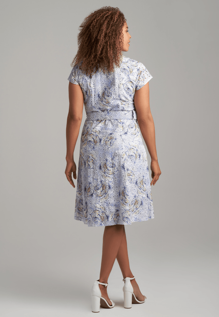 Woman wearing blue rose printed cotton eyelet short dress with belt by Ala von Auersperg for spring summer 2022