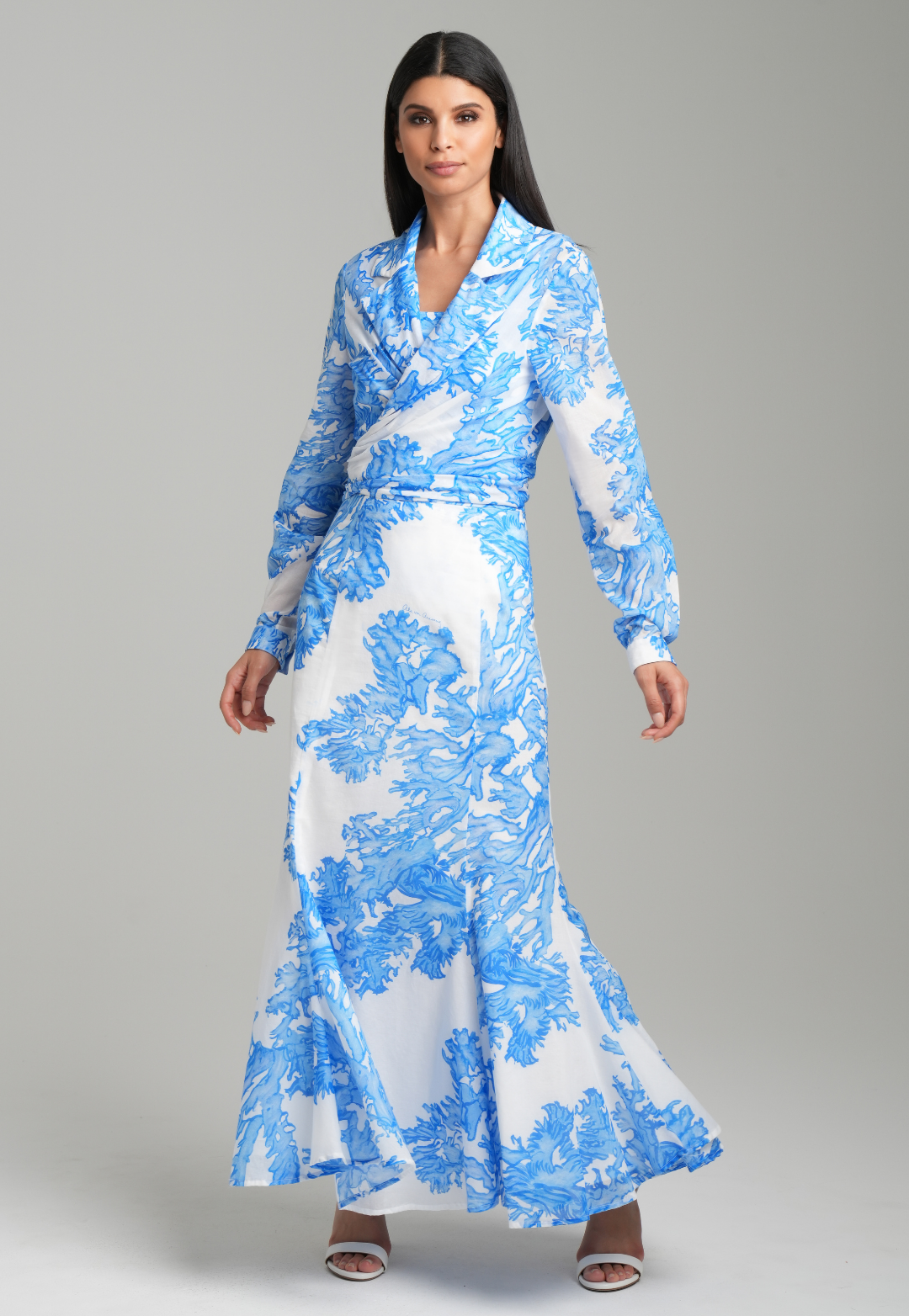 Woman wearing blue coral printed cotton voile long skirt with blue coral printed square neck stretch knit tank top and blue coral printed cotton wrap top by Ala von Auersperg for resort 2023