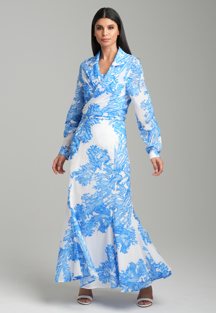 Woman wearing blue coral printed cotton voile long skirt with blue coral printed square neck stretch knit tank top and blue coral printed cotton wrap top by Ala von Auersperg for resort 2023