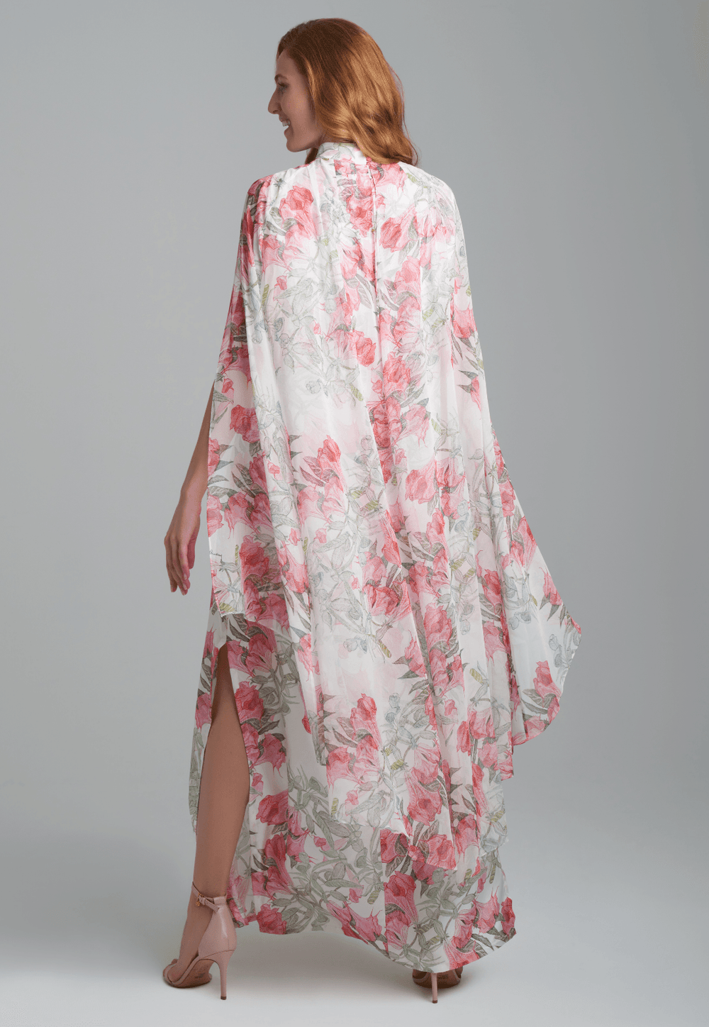 Woman wearing flower printed long turtleneck silk dress with silk attached cape by Ala von Auersperg for spring summer 2022