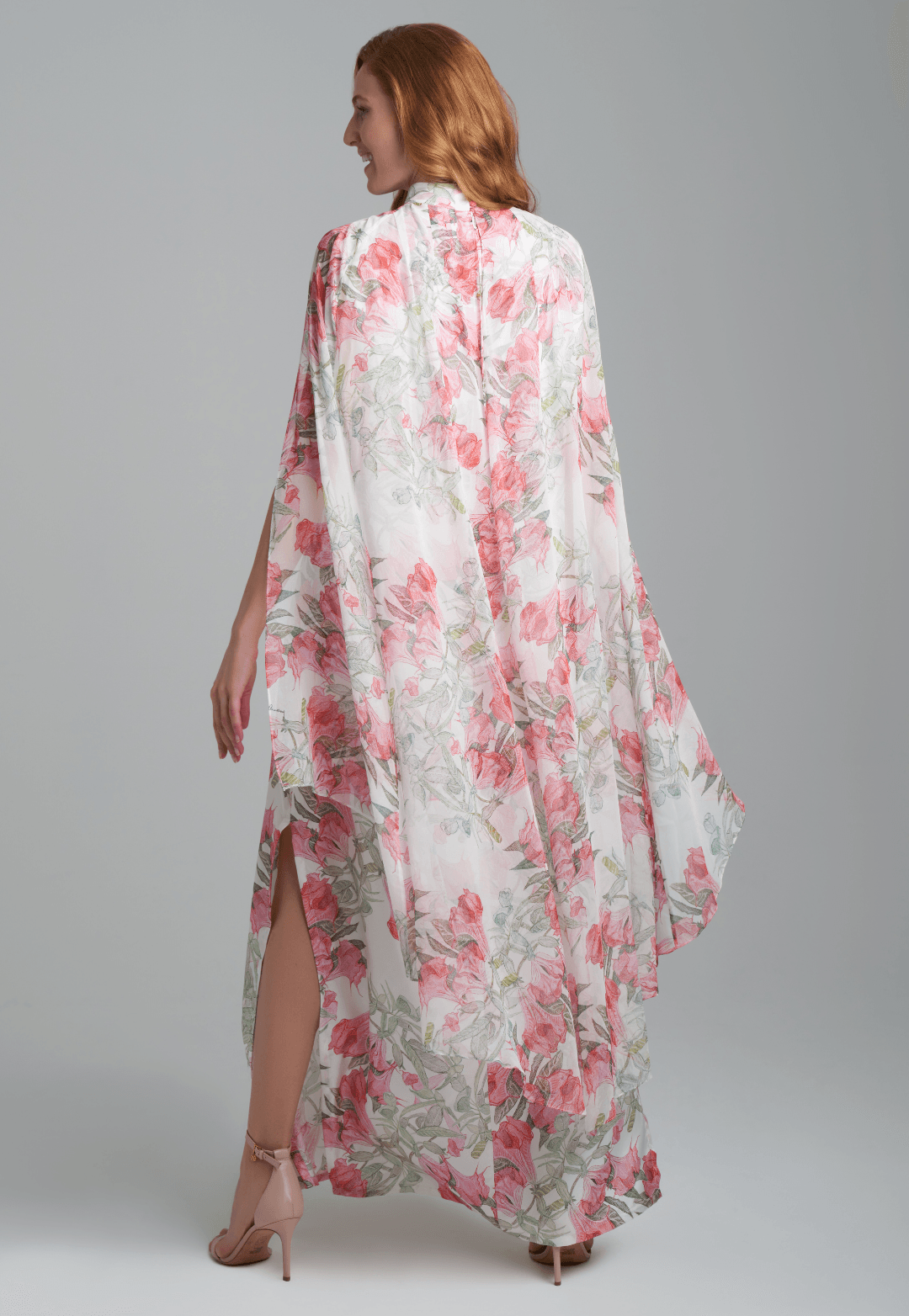 Woman wearing flower printed long turtleneck silk dress with silk attached cape by Ala von Auersperg for spring summer 2022
