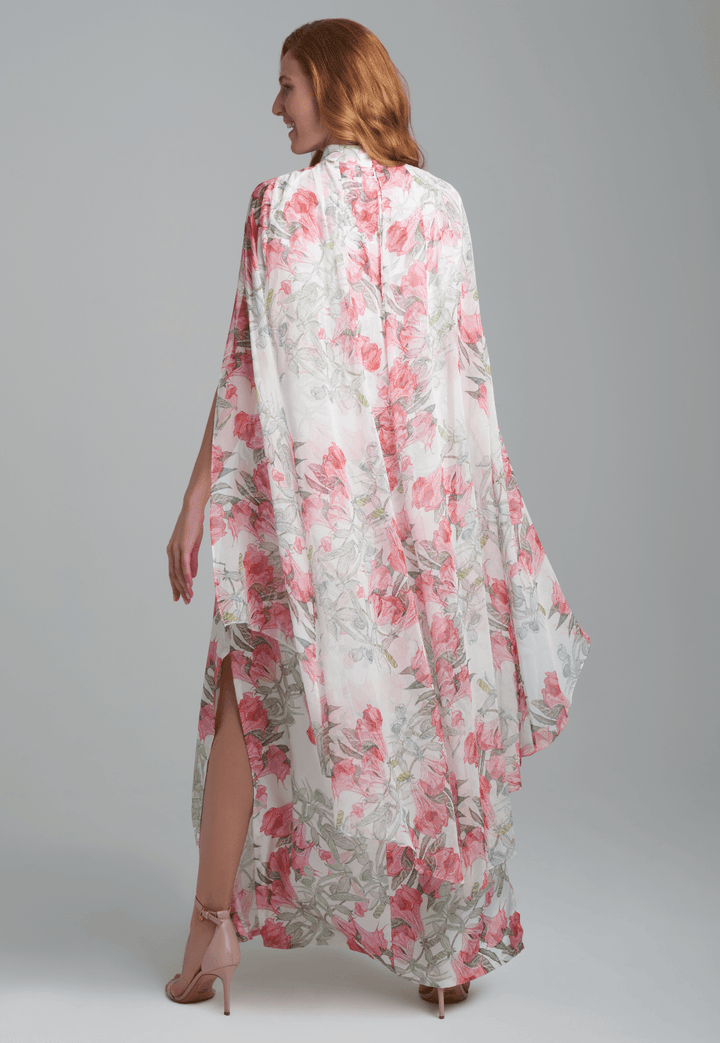 Woman wearing flower printed long turtleneck silk dress with silk attached cape by Ala von Auersperg for spring summer 2022