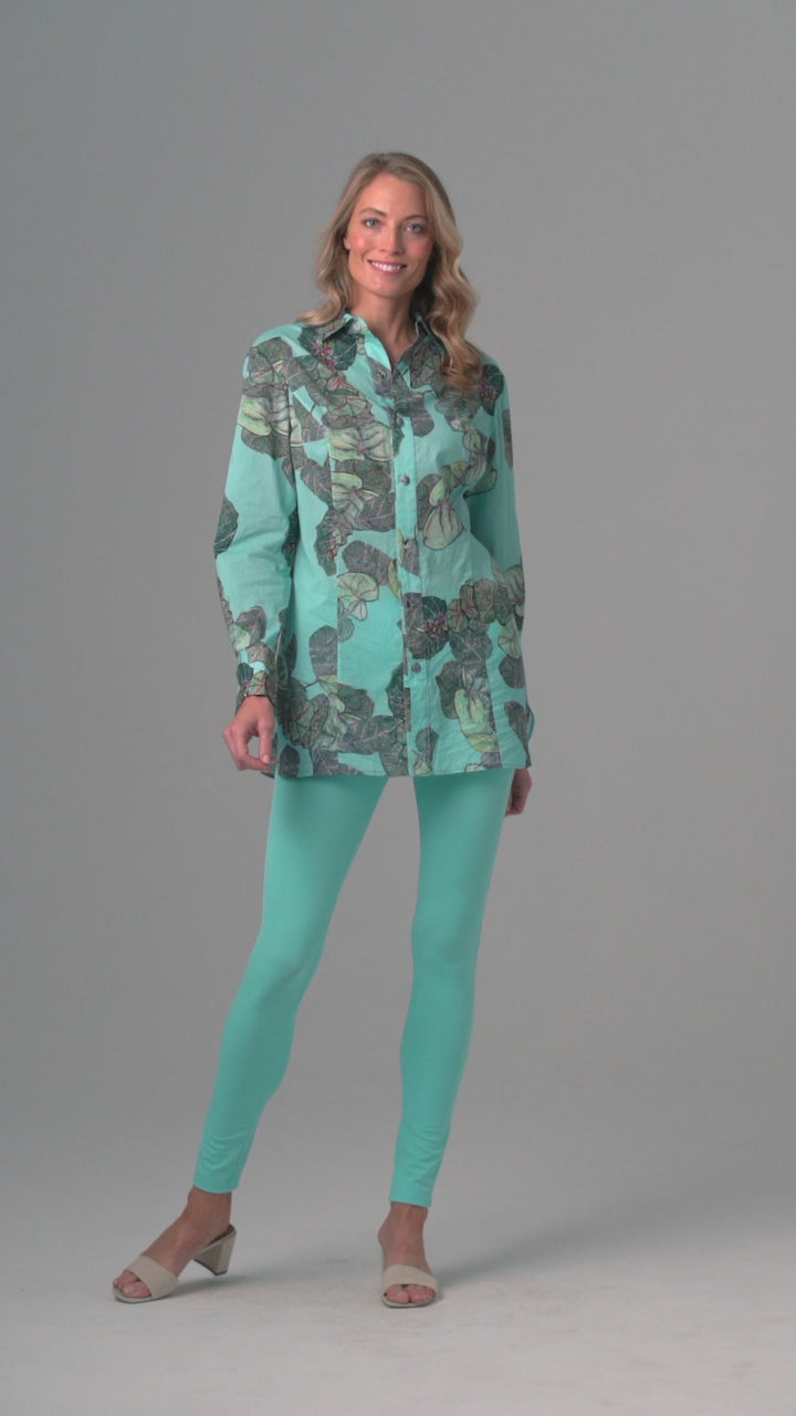 Woman wearing grape leaf cotton blouse with stretch knit blue pants by Ala von Auersperg for resort 2022