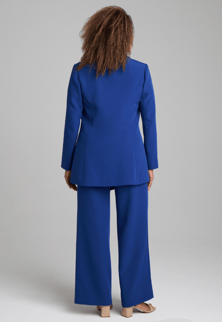 Woman wearing silk lined sapphire blazer with printed silk shell tank top and stretch blue pants suite by Ala von Auersperg for fall 2022