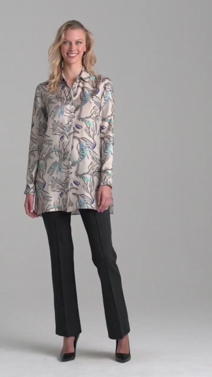 Woman wearing feather printed silk blouse and plaid stretch knit pants by Ala von Auersperg for fall 2022