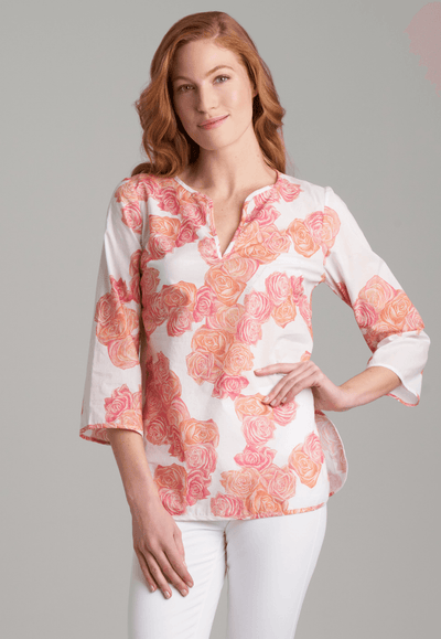 Woman wearing cotton rose printed tunic with stretch knit white pants by Ala von Auersperg for spring summer 2022