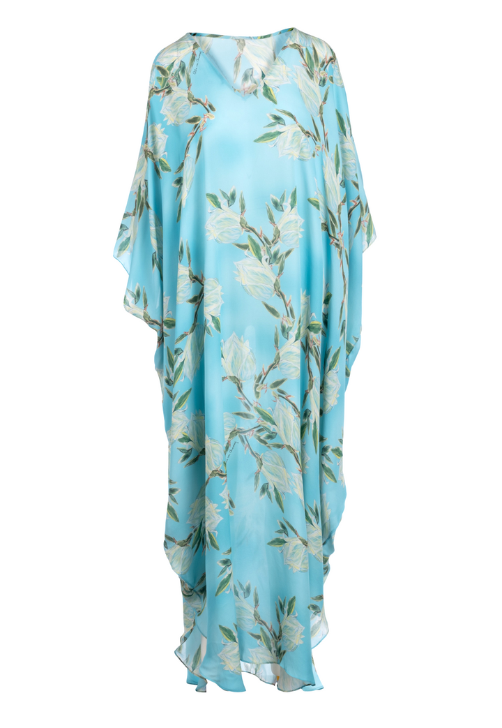 Woman wearing blue silk yucca printed long kaftan with v neck by Ala von Auersperg for spring 2023